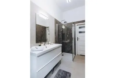 a white bathroom with a sink and a shower at Apartment with balcony - 21 Filipa Street in Kraków