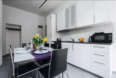 a kitchen with a table and chairs and a microwave at Apartment with balcony - 21 Filipa Street in Kraków