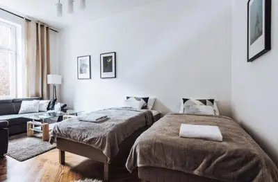 a bedroom with two beds and a couch at Apartment with balcony - 21 Filipa Street in Kraków