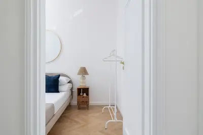 a bedroom with a white bed and a mirror at 4-Bedroom Apartment - Private Sauna - Wielopole 7 in Kraków