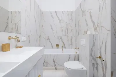 a white bathroom with a toilet and a sink at 4-Bedroom Apartment - Private Sauna - Wielopole 7 in Kraków