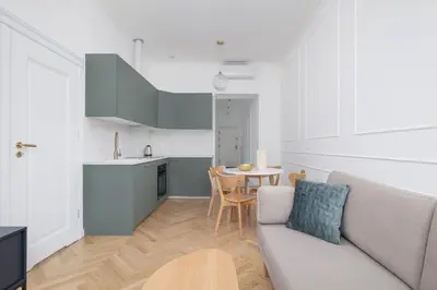 a living room with a couch and a table at 4-Bedroom Apartment - Private Sauna - Wielopole 7 in Kraków