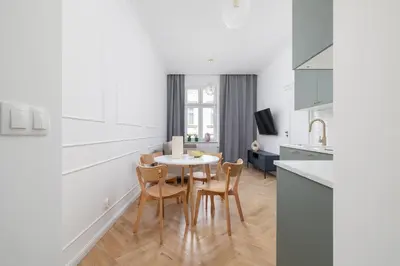 a kitchen and dining room with a table and chairs at 4-Bedroom Apartment - Private Sauna - Wielopole 7 in Kraków