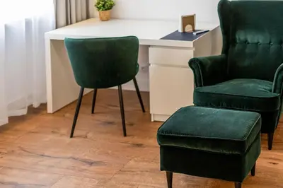 two green chairs and a desk with a chair at Józefińska Deluxe Studio by BookingHost in Kraków