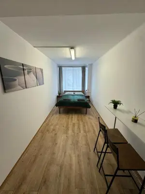 a living room with a green bed in a window at Nice rooms in City Center Kraków in Kraków