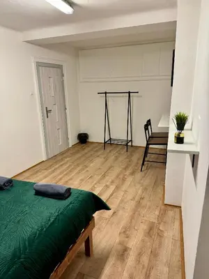 a bedroom with a bed and a wooden floor at Nice rooms in City Center Kraków in Kraków