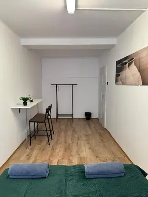 a bedroom with a bed and a table and a desk at Nice rooms in City Center Kraków in Kraków