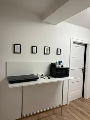 a white table with a laptop on top of it at Nice rooms in City Center Kraków in Kraków