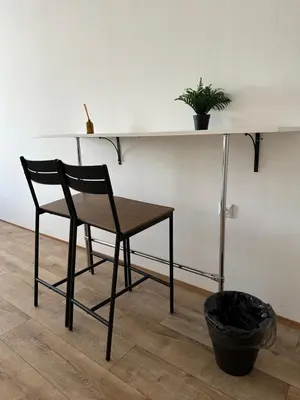 a chair sitting under a desk with a plant on it at Nice rooms in City Center Kraków in Kraków