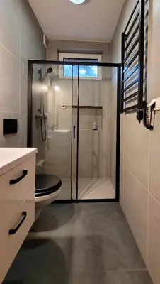 a bathroom with a shower with a toilet and a glass door at Domek Abi in Rabka-Zdroj