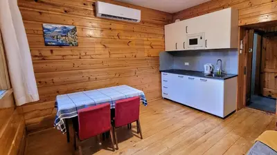 a kitchen with a table and chairs in a room at Domek Abi in Rabka-Zdroj