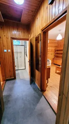 an open door in a room with wooden walls at Domek Abi in Rabka-Zdroj