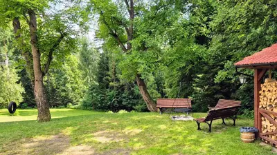 a park with two benches and a gazebo at Domek Abi in Rabka-Zdroj