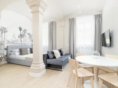 a living room with a couch and a table at Apartment - Main Square in Kraków