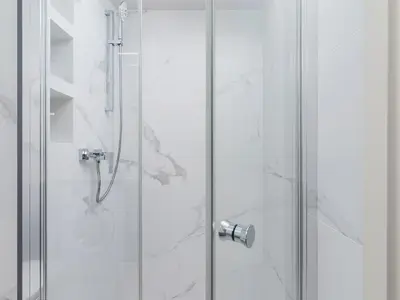 a shower with a glass door in a bathroom at Apartment - Main Square in Kraków