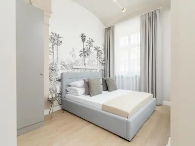 a white bedroom with a bed and a window at Apartment - Main Square in Kraków