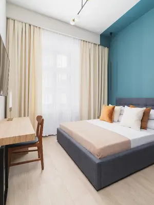 a bedroom with a bed and a table and a desk at Main square - Apartment with 2 bedrooms in Kraków