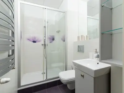 a bathroom with a shower and a toilet and a sink at Main square - Apartment with 2 bedrooms in Kraków