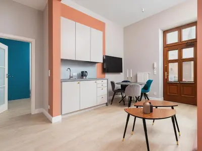 a kitchen and dining room with a table and a kitchen and a living room at Main square - Apartment with 2 bedrooms in Kraków