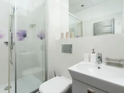 a bathroom with a shower and a toilet and a sink at Main square - Apartment with 2 bedrooms in Kraków