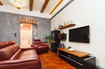 a living room with a couch and a flat screen tv at Luxury Apartment - Kazimierz District in Kraków