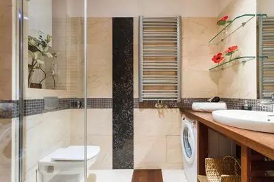 a bathroom with a shower and a toilet and a sink at Luxury Apartment - Kazimierz District in Kraków