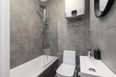 a bathroom with a shower and a toilet and a sink at Zyblikiewicza 5- Studio Apartment- Old Town in Kraków