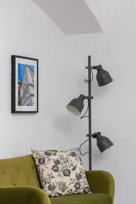 a living room with a green couch and a lamp at Zyblikiewicza 5- Studio Apartment- Old Town in Kraków
