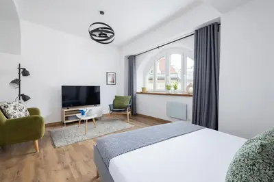 a hotel room with a bed and a tv at Zyblikiewicza 5- Studio Apartment- Old Town in Kraków