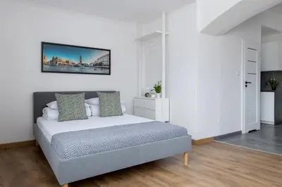 a bedroom with a bed in a white room at Zyblikiewicza 5- Studio Apartment- Old Town in Kraków