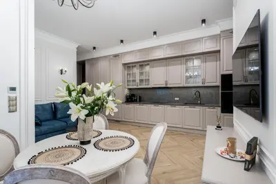 a kitchen with a table with a vase of flowers at Apartament w sercu Krakowa in Kraków