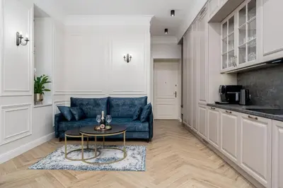a living room with a blue couch and a table at Apartament w sercu Krakowa in Kraków