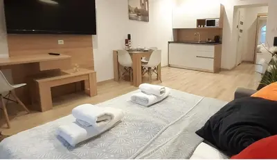 a living room with white towels on a couch at Old Town Apartments - B12 in Kraków