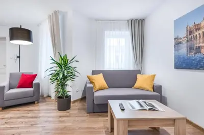 a living room with a couch and a table at Old Town Apartments - B12 in Kraków