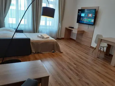 a room with a bed and a flat screen tv at Old Town Apartments - B20 in Kraków
