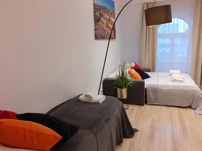 a living room with a bed and a lamp at Old Town Apartments - B20 in Kraków