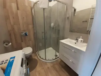 a bathroom with a shower and a toilet and a sink at Old Town Apartments - B20 in Kraków