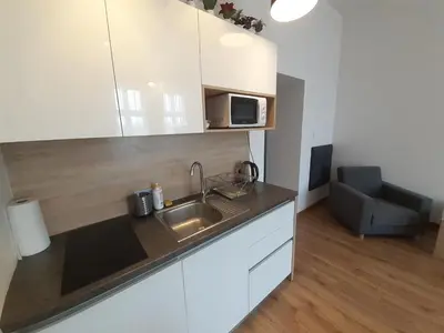 a kitchen with a sink and a microwave at Old Town Apartments - B20 in Kraków
