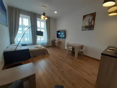 a living room with a bed and a table at Old Town Apartments - B20 in Kraków