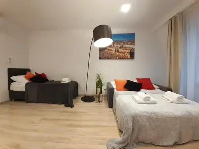 a living room with two beds and a lamp at Old Town Apartments - B20 in Kraków