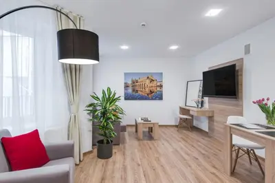a living room with a couch and a table and a tv at Old Town Apartments - B34 in Kraków