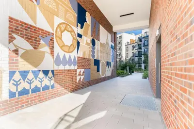 an alley with a mural on the side of a building at Quantum Premium Apartment & Free Parking! in Kraków