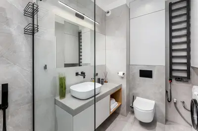 a bathroom with a sink and a toilet and a mirror at Quantum Premium Apartment & Free Parking! in Kraków
