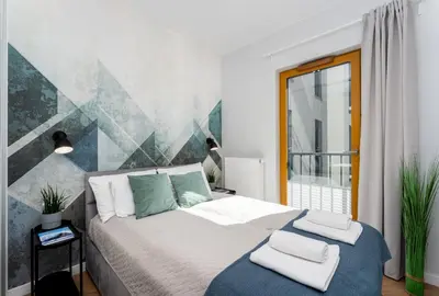 a bedroom with a bed with two towels on it at Quantum Premium Apartment & Free Parking! in Kraków