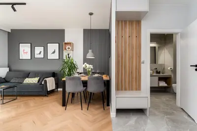 a living room and dining room with a table and chairs at Quantum Premium Apartment & Free Parking! in Kraków