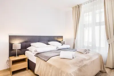 a bedroom with two beds with white towels on them at Old Town Apartments - B19 in Kraków