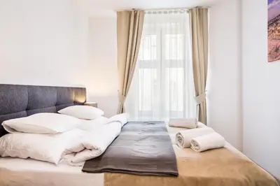 a bedroom with a large bed with white pillows at Old Town Apartments - B19 in Kraków