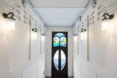 a hallway with a door with a stained glass window at Old Town Apartments - B19 in Kraków
