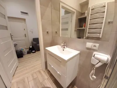 a bathroom with a sink and a phone at Old Town Apartments - B7 in Kraków