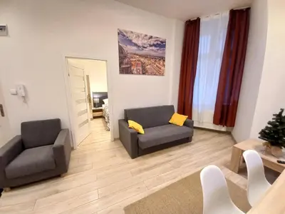 a living room with two chairs and a couch at Old Town Apartments - B7 in Kraków